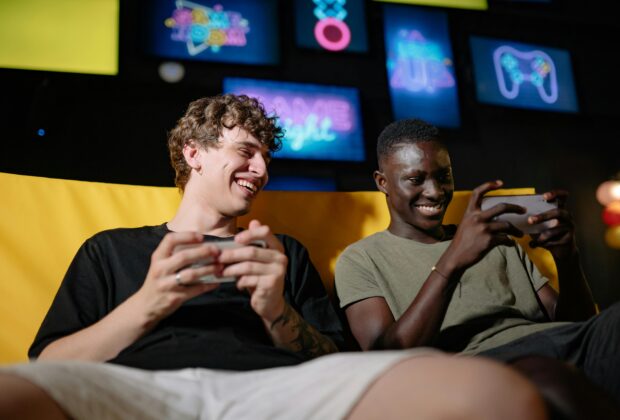 best gaming phone, people playing on the couch holding mobile phones