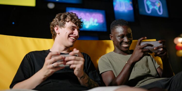 best gaming phone, people playing on the couch holding mobile phones