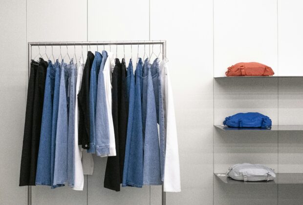 clean capsule wardrobe, clothes stacked, hanged clothes, denim pants, chambray shirts, bags