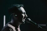 iem earphones, side view of a man singing
