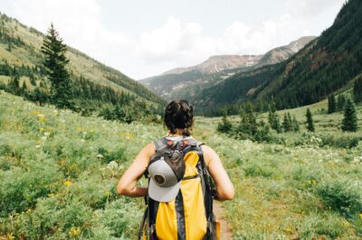 solo travel, backpacker, traveller backpacking between mountains, valley