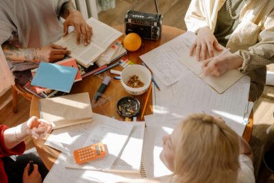 study techniques, student notes on desk, calculator, radio, orange, tattoos, groupwork, homework