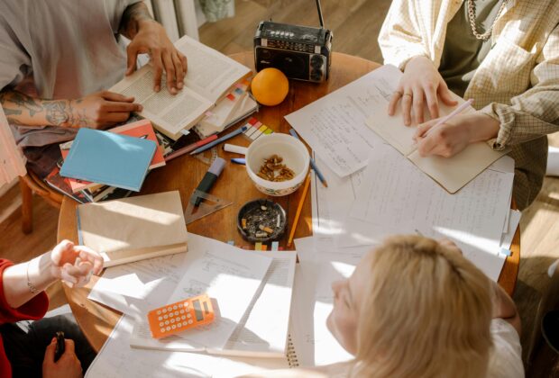 study techniques, student notes on desk, calculator, radio, orange, tattoos, groupwork, homework