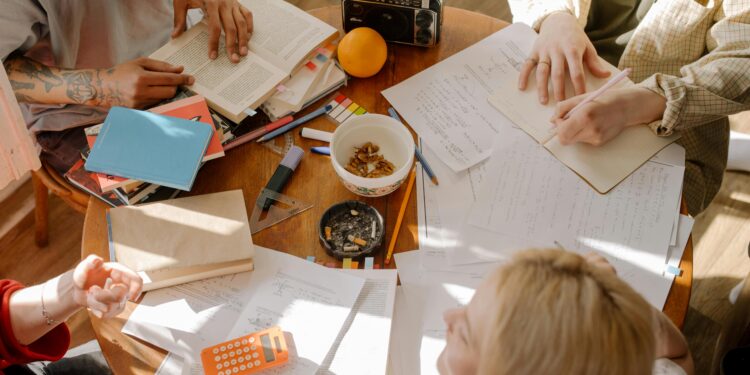 study techniques, student notes on desk, calculator, radio, orange, tattoos, groupwork, homework