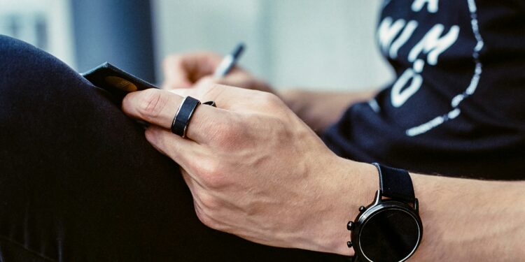 wearables - arm wearing smartwatch and smart ring