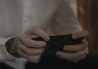 spot fake game ads easily - a man holding a phone