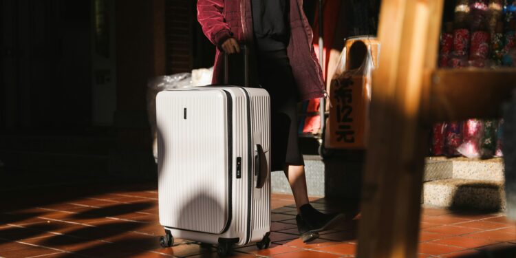 tips to enjoy your holidays when bored - woman walking with white luggage
