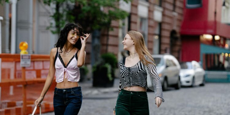 Two Teenage Girls in Trendy Y2K Fashion Clothing Walking in the City