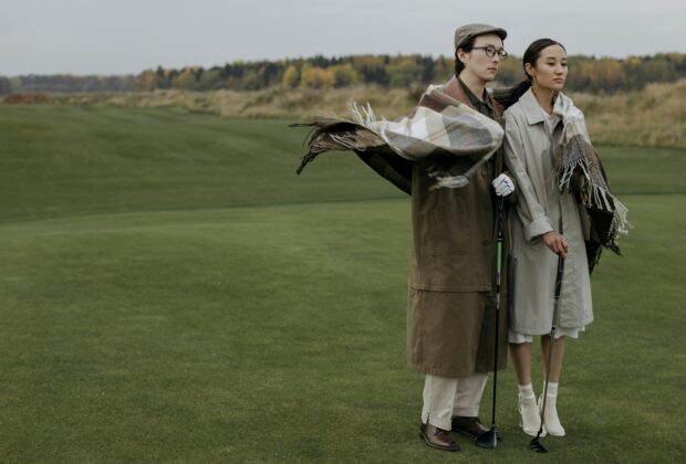lovers standing together in old money outfits