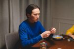 poker shark photo of a man in a blue sweatshirt playing poker