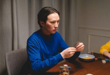 poker shark photo of a man in a blue sweatshirt playing poker
