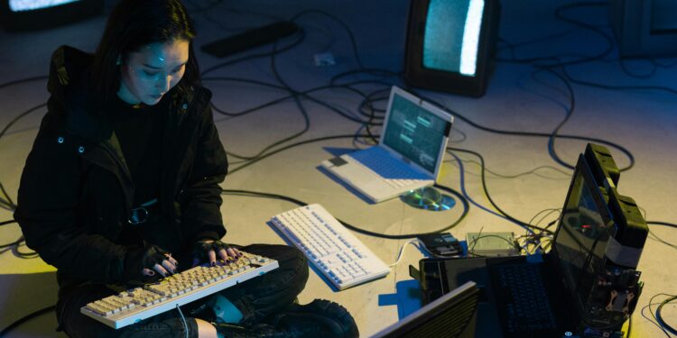 a woman typing on the keyboard for cybersecurity