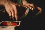 person shuffling uno cards for card games with friends