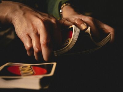 person shuffling uno cards for card games with friends