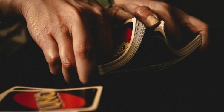 person shuffling uno cards for card games with friends