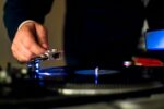 person holding a phonograph for vinyl records
