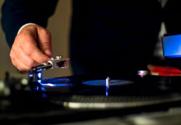 person holding a phonograph for vinyl records