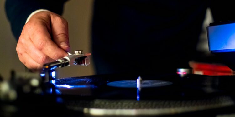 person holding a phonograph for vinyl records