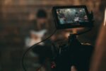 unknown person playing guitar in front of a live stream camera