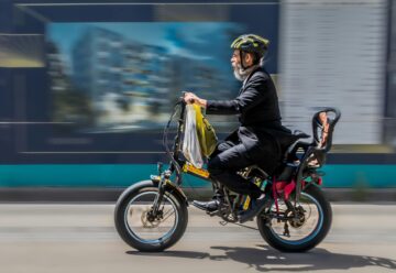 side view of a man riding an electric cycle bike