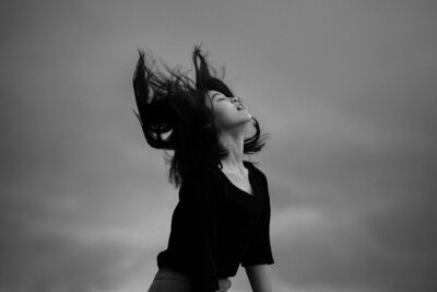 woman in black shirt with black butterfly haircut