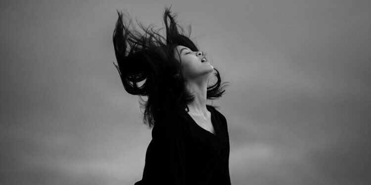woman in black shirt with black butterfly haircut