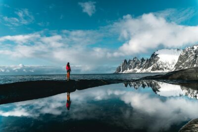 person standing near a body of water creating inspiration for travel quotes