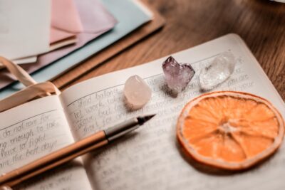 sample of a spiritual journal writing set up with crystals and a dried citrus