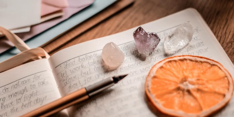 sample of a spiritual journal writing set up with crystals and a dried citrus