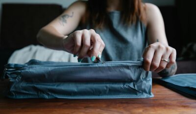 Woman zipping a bag from a set of packing cubes