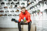 man sitting and shopping for sports shoes for men