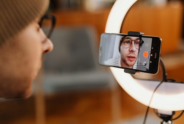 man filming short video on smartphone