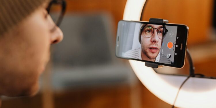 man filming short video on smartphone