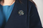 sample of vintage brooches on woman's coat