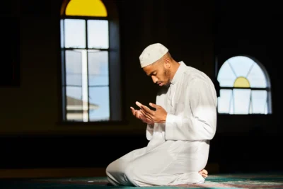 man observing islamic prayer times
